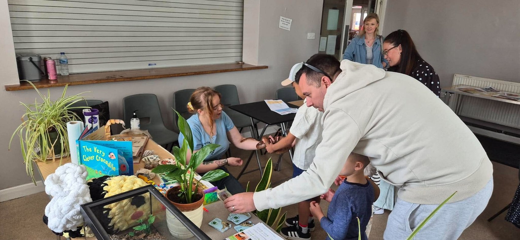 A child taking part in a hands-on animal interaction